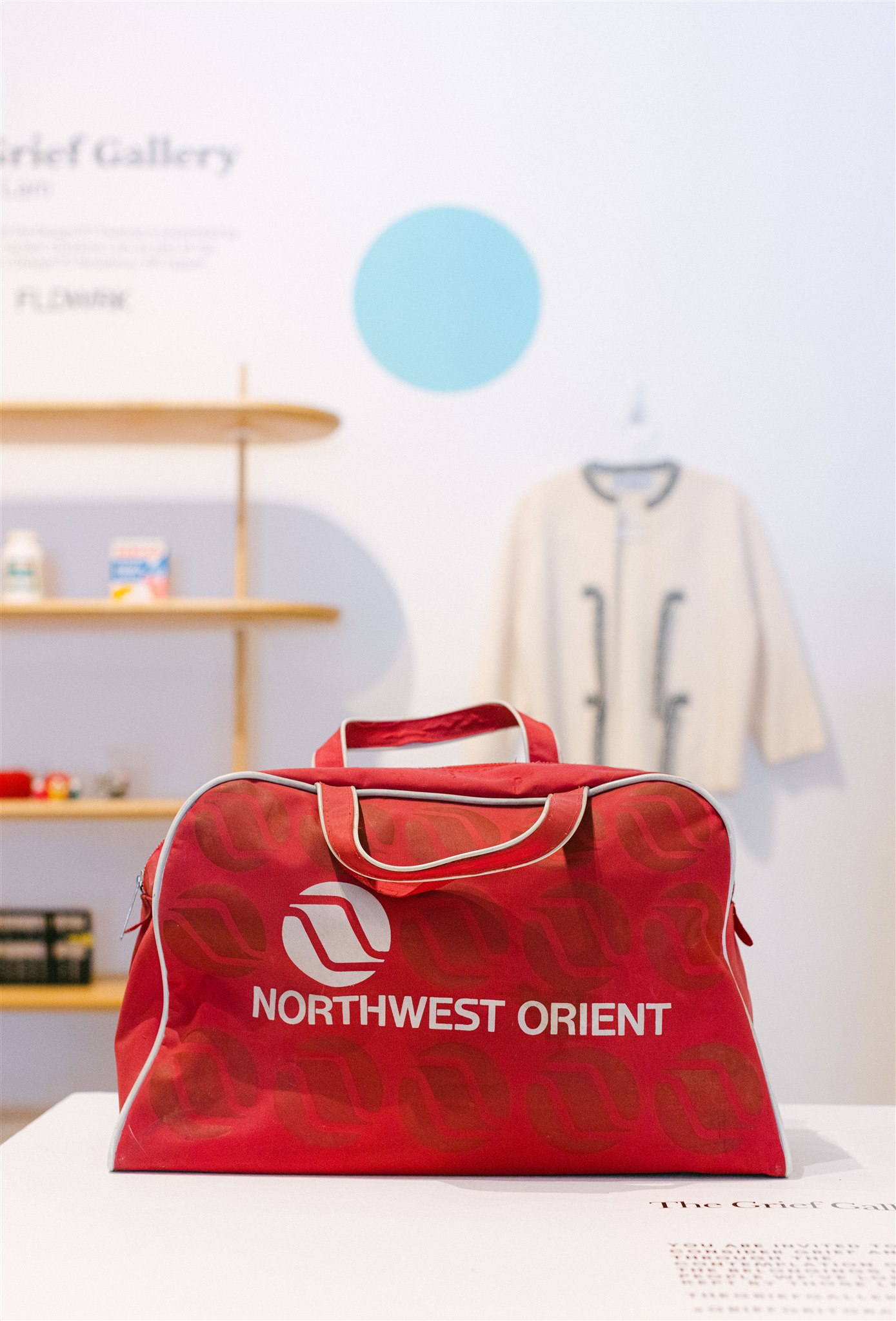 Red vintage travel bag in a gallery