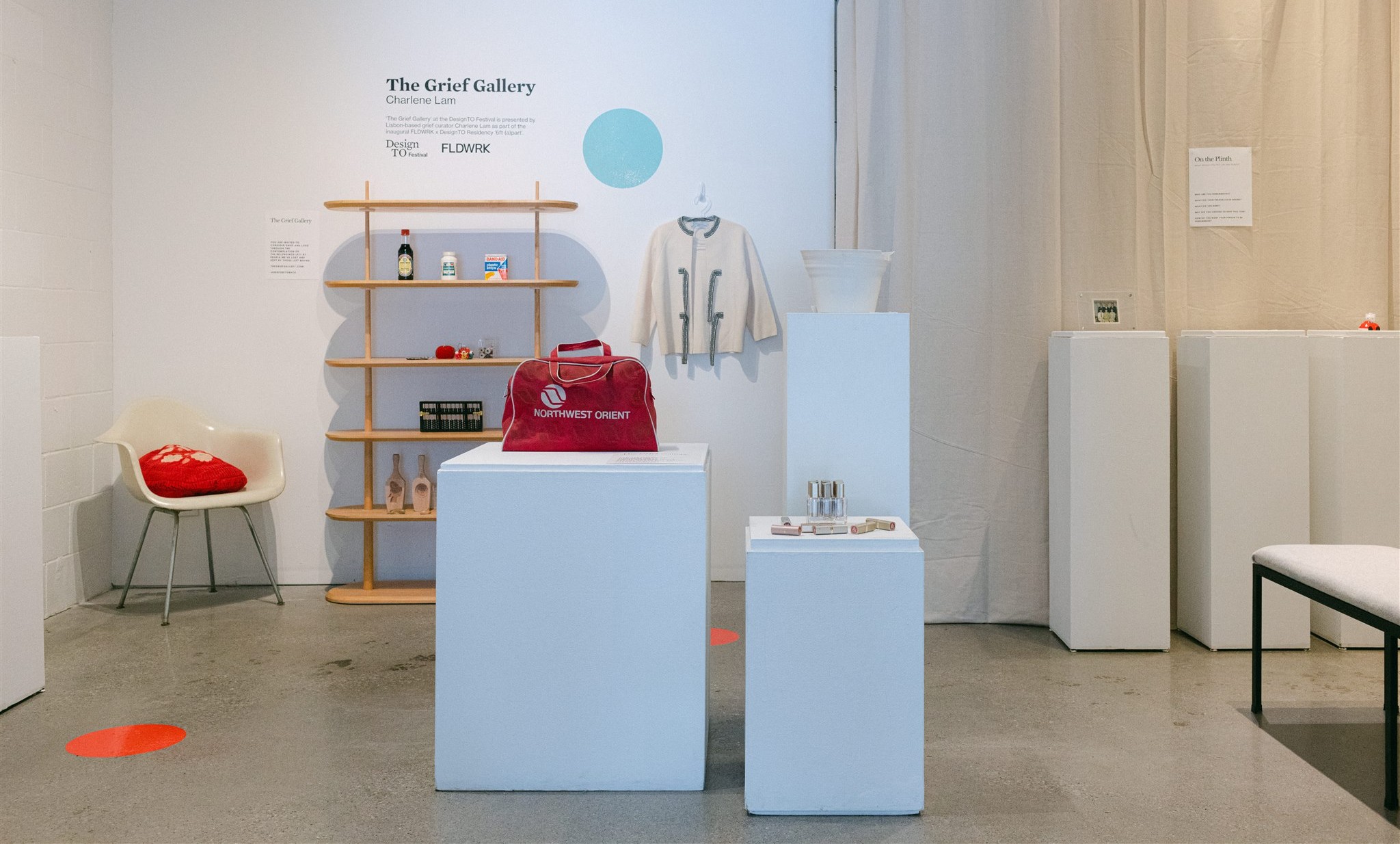 Gallery with white plinths and assortment of objects on them