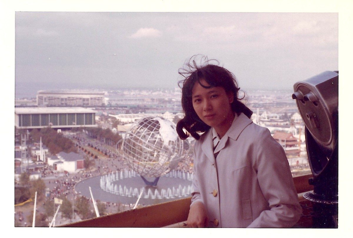 Young Asian woman pictured with the 1964 World's Fair Unisphere in Queens, NY