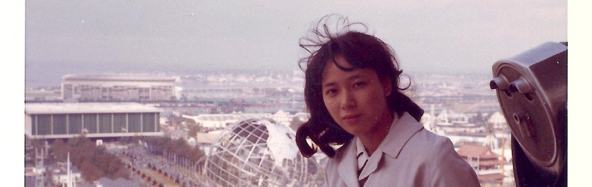 Young Asian woman pictured with the 1964 World's Fair Unisphere in Queens, NY