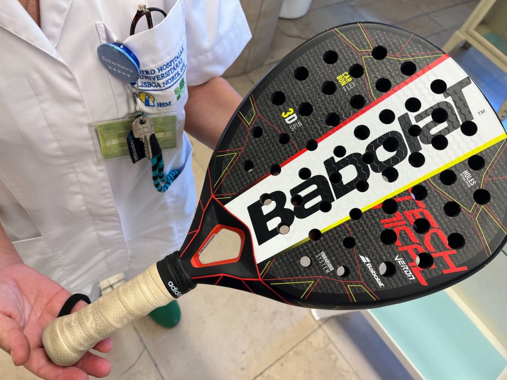 Young Asian woman in dress standing next to Buick car 1960s